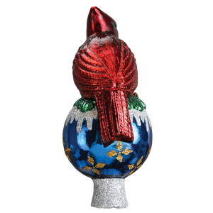 A glossy red cardinal tree topper perched on a blue glass Christmas tree topper with gold leaf and silver glitter details