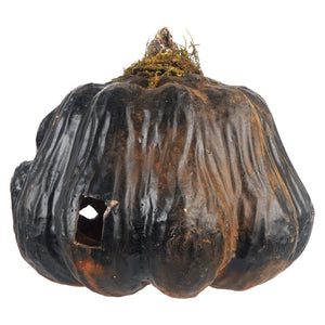 A rustic black smiling ceramic pumpkin jack o lantern with textured surface and mossy stem perfect for tea light use