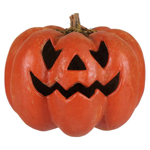 Carved orange grinning face pumpkin jack-o-lantern lantern with triangular eyes nose and wavy mouth