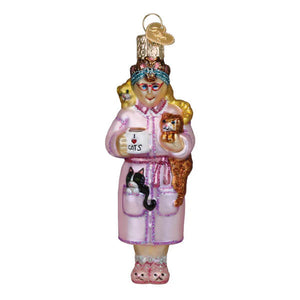 Pink glass christmas glass ornament featuring a cat lady ornament holding a mug surrounded by cats family owned style