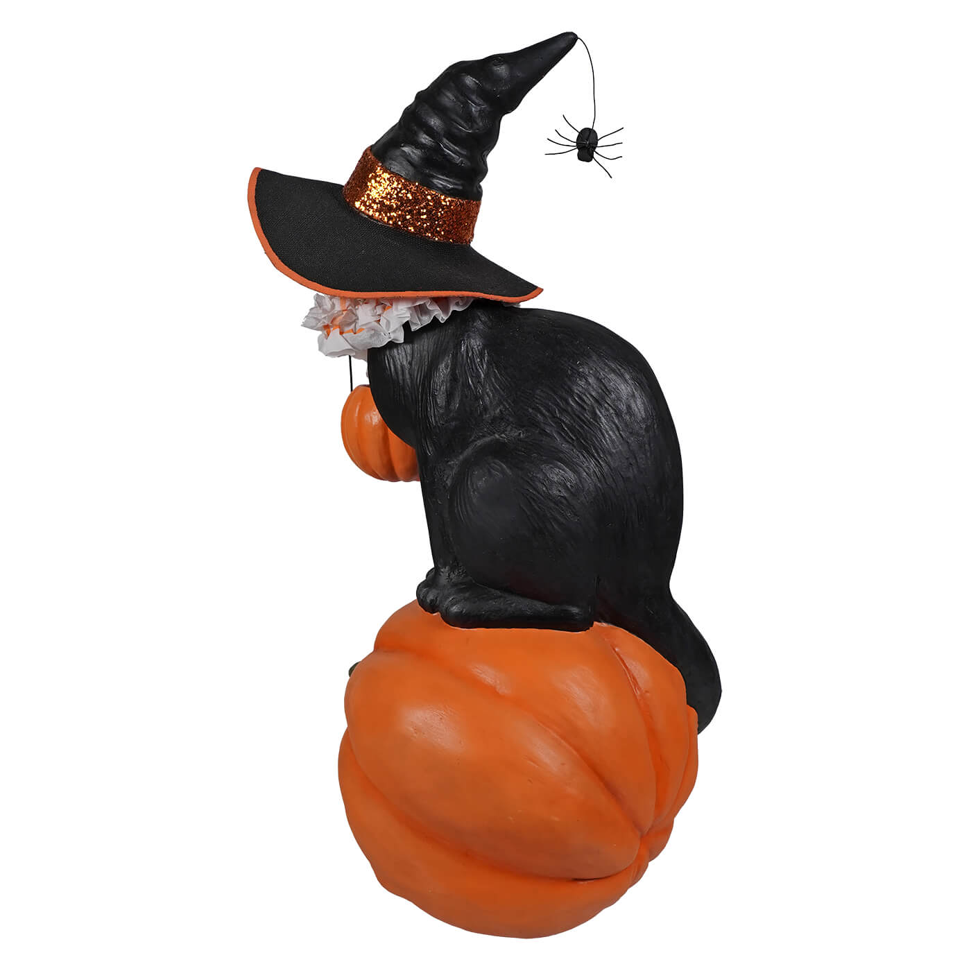 Black cat witch figurine with glittery orange band and spider detail sitting on an orange pumpkin for halloween witch decor