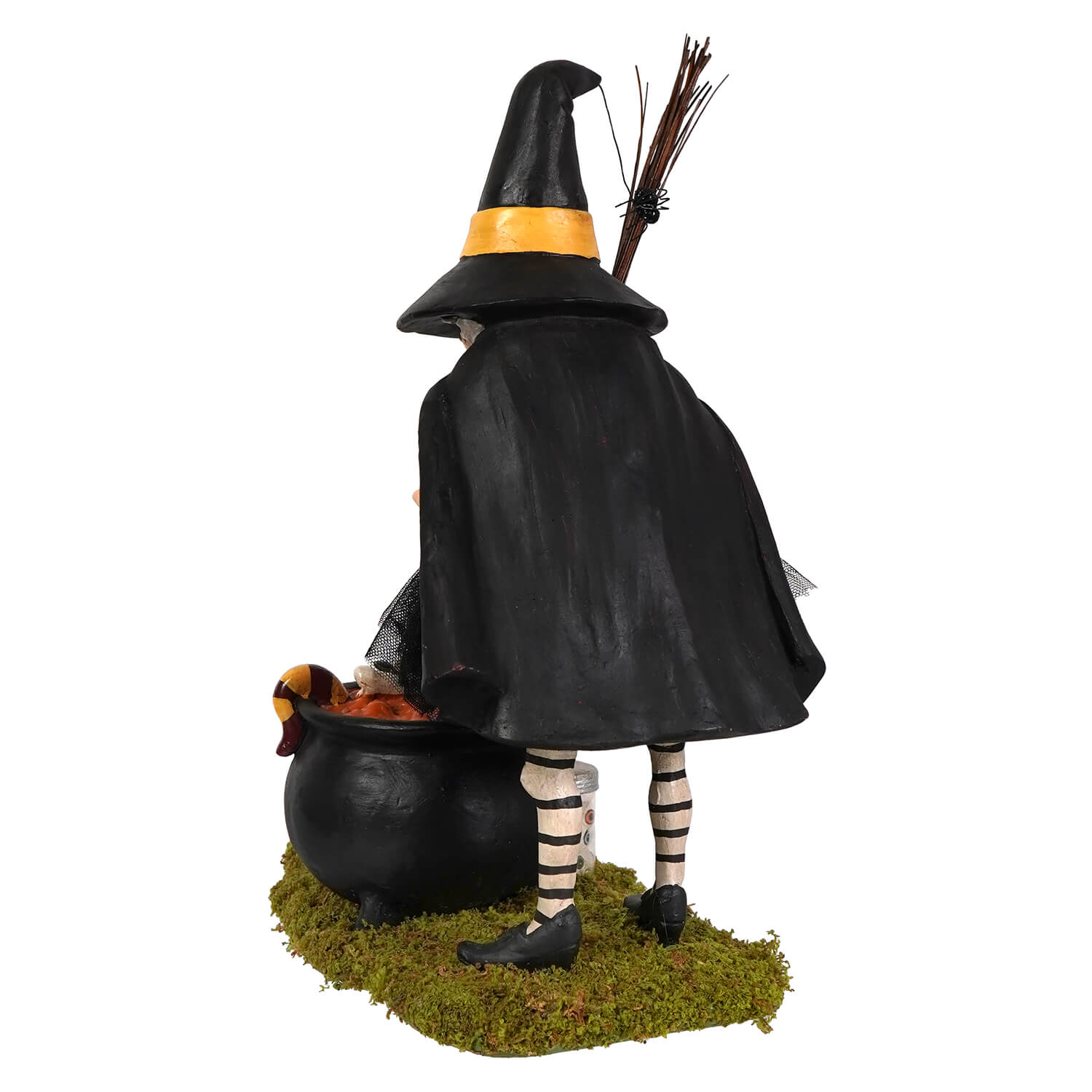 Black cauldron cooking witch figurine with yellow-trimmed hat and striped stockings standing beside mossy cauldron base