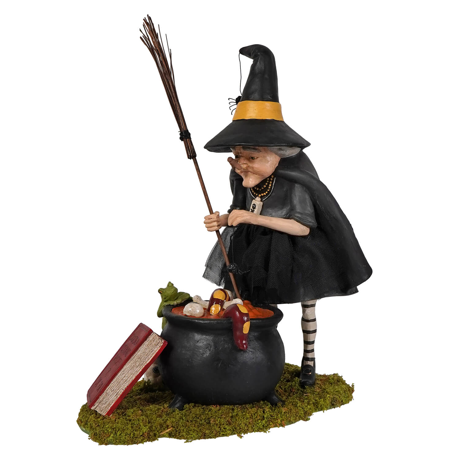 Black cauldron cooking witch figurine with yellow-trimmed hat stirring colorful ingredients in a cauldron