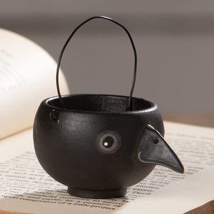 Black cast iron bird-shaped caw egg cup with curved wire handle and detailed eye by bethany lowe halloween