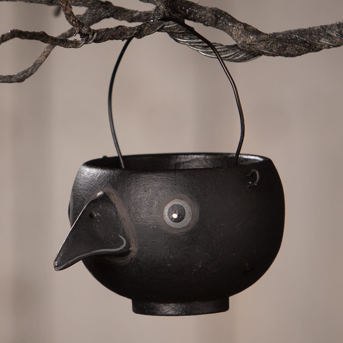 Black cast iron bird-shaped hanging egg cup with long beak and round eye by bethany lowe halloween