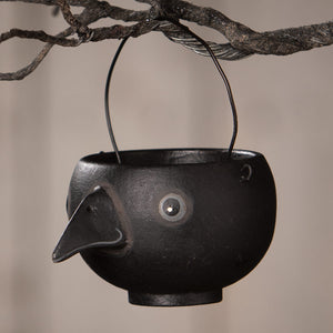 Black cast iron bird-shaped hanging egg cup with long beak and round eye by bethany lowe halloween