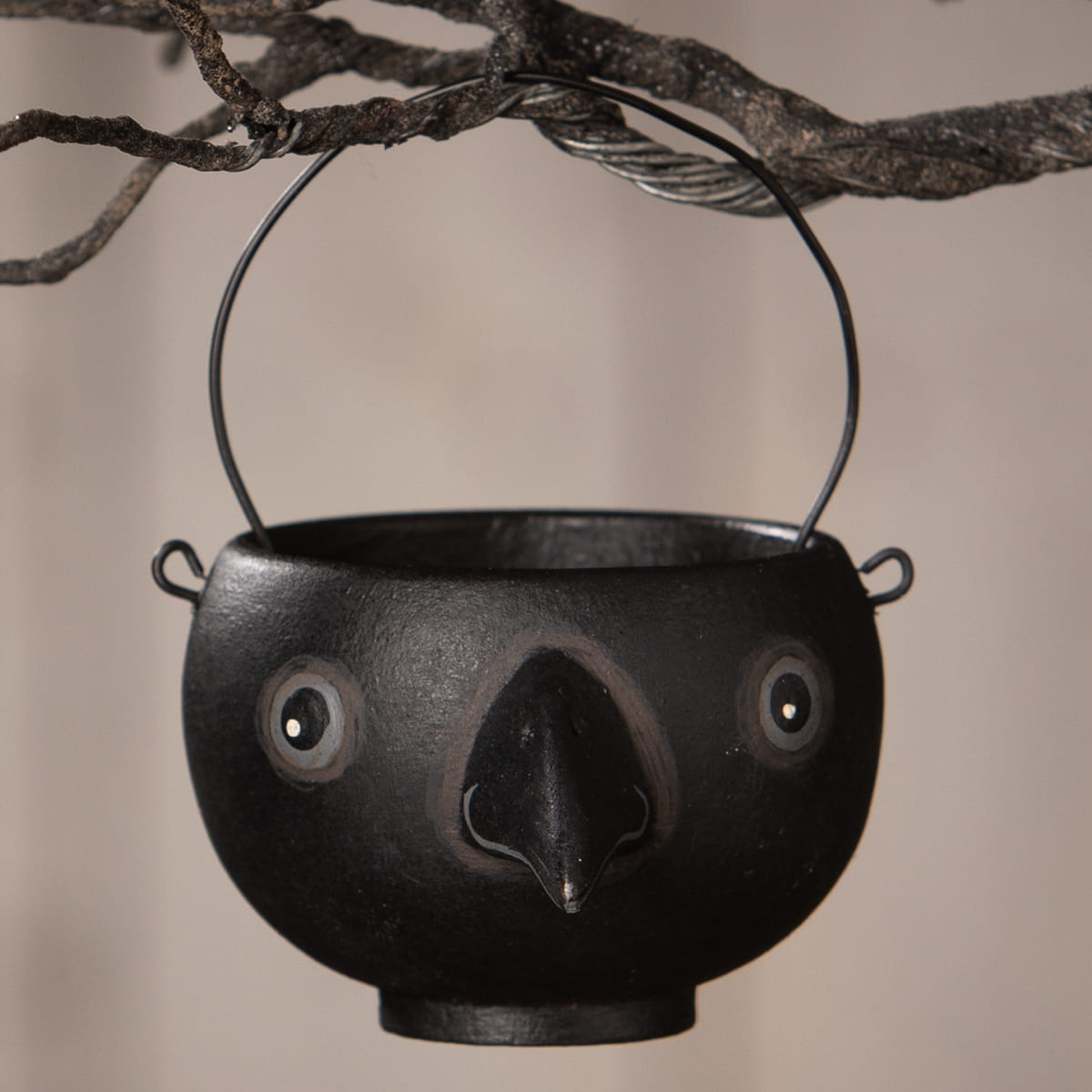 Black cast iron bird-shaped caw egg cup with painted eyes and beak by bethany lowe halloween