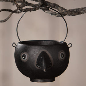 Black cast iron bird-shaped caw egg cup with painted eyes and beak by bethany lowe halloween