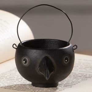 Black cast iron cauldron shaped bethany lowe halloween egg cup with googly eyes and wire handle called caw egg cup