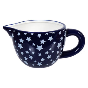 Navy blue ceramic creamer pitcher decorated with white stars.