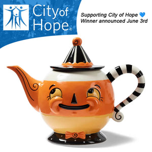 A cheerful orange and white ceramic candy corn spooks teapot by johanna parker with a striped handle and witch hat