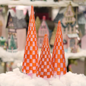 Three vibrant checkered patterned red and pink glass tree ornaments with a glossy finish for christmas trees