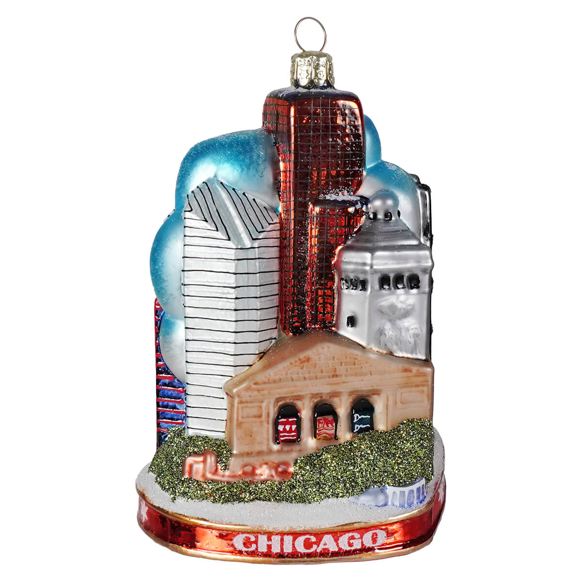 This chicago cityscape glass ornament features a red silver and beige skyline with blue clouds and green glitter grass base