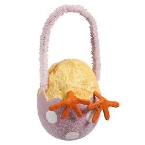 A pink polka-dotted egg-shaped bethany lowe chick tail ornament with a fuzzy handle and a yellow chick inside perfect for easter eggs and decorative grass
