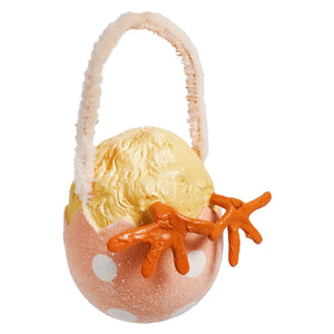 A pink polka-dotted bethany lowe chick tail ornament egg basket with fluffy handle holding yellow chick figurine