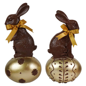 Chocolate rabbits with gold ribbons sitting on ornate golden eggs perfect for vintage easter bunny figural decor