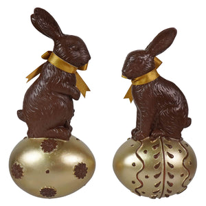 Chocolate rabbits with gold ribbons sitting on ornate golden eggs vintage easter bunny figural decor for tabletop