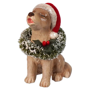 A tan resin bethany lowe design christmas caroling dog figurine wearing a red santa hat and frosted holly wreath
