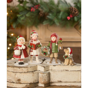 Christmas caroling leah with book figurine set features three kids and a dog in festive red white green attire perfect for christmas tabletop decor