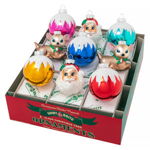 Vibrant glossy glass christmas confetti rounds in pink blue red and gold with white glittery snowcap designs