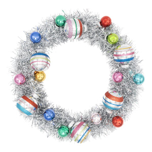 A festive silver holiday splendor tinsel wreath with colorful striped glass ornaments by christopher radko