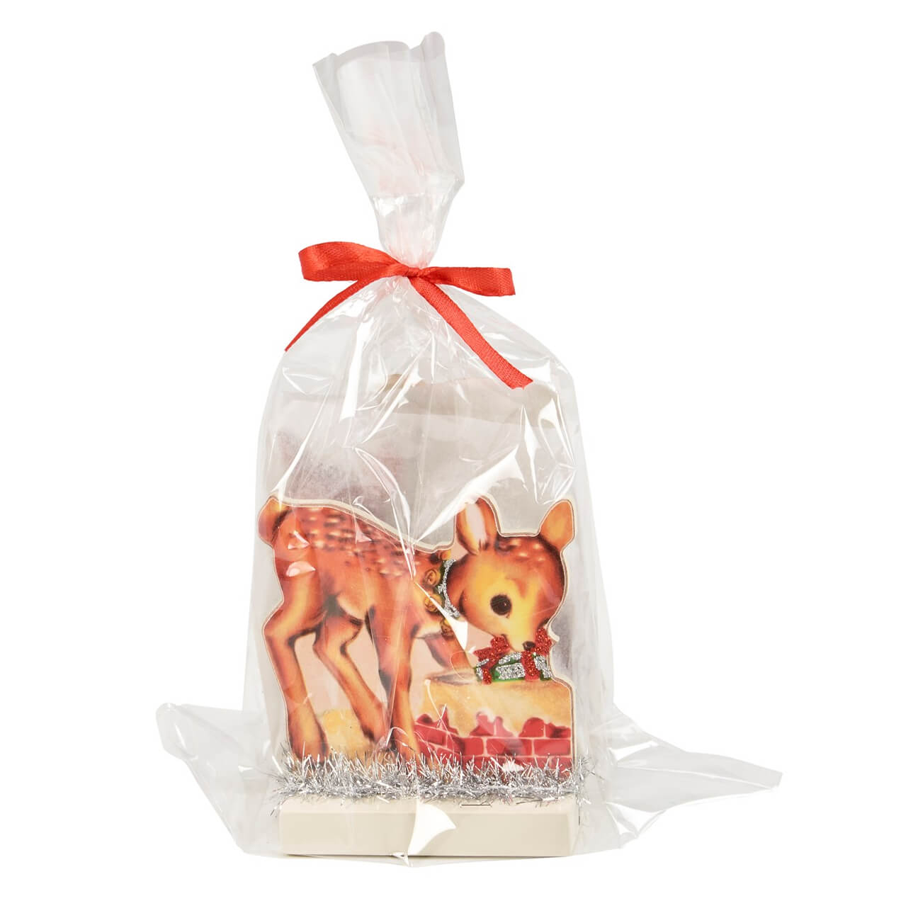 Gift bag containing decorative deer figurines tied with a red ribbon.