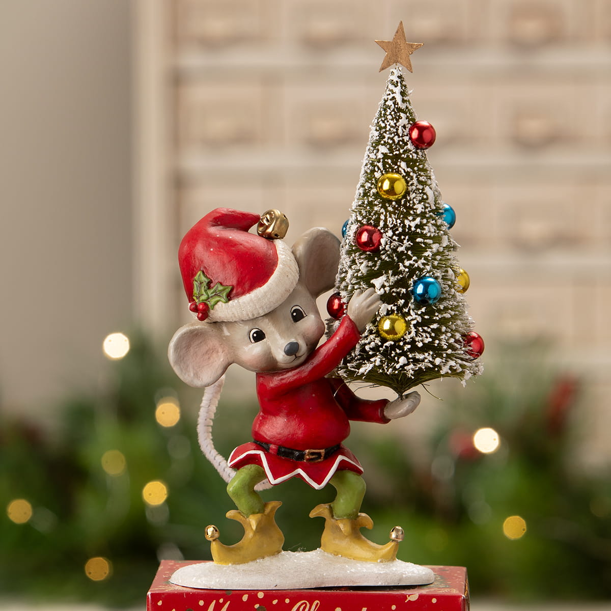 A charming bethany lowe christmas mouse gus figurine in a red and white santa hat holding a decorated tree