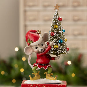 A charming bethany lowe christmas mouse gus figurine in a red and white santa hat holding a decorated tree