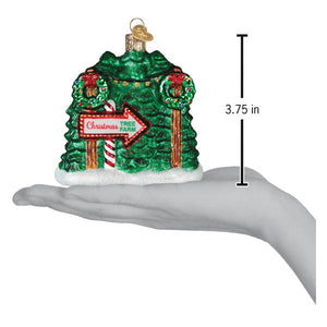 Green glass christmas tree farm ornament with red and white candy cane accents and gold trim with directional sign