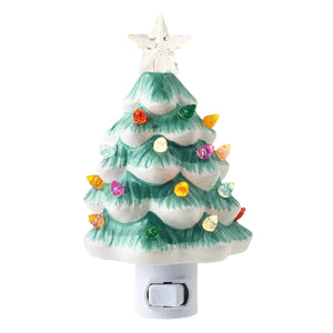 A ceramic christmas tree night light with a white base green and white branches colorful glass bulbs and clear star topper