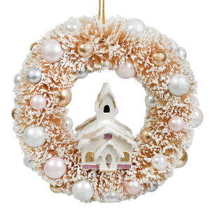 Frosted peach-colored christmas wreath ornament with a miniature white church accented with pink glitter and pearl beads by bethany lowe