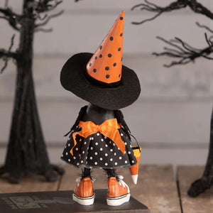 A charming orange and black polka-dotted witch pumpkin sitter with ribbon bow and candy corn from bethany lowe halloween figures & dolls