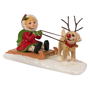 Claire with puppy holiday figurine by bethany lowe shows a child in red and green coat sledding with tan puppy reindeer
