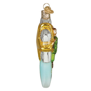 Clear glass christmas glass ornament shaped like vintage car with gold glitter and small peter pan figurine in green