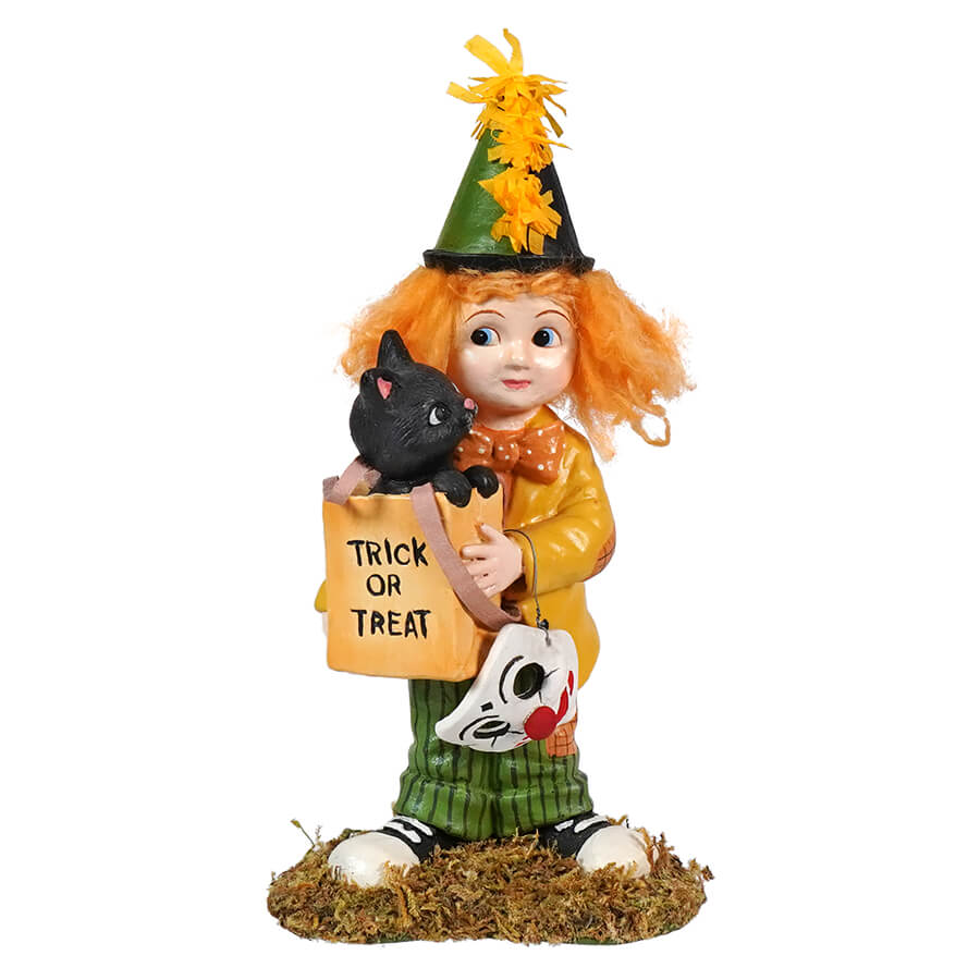 Halloween-themed figurine of a child dressed as a witch holding a black cat and a ’Trick or Treat’ sign.