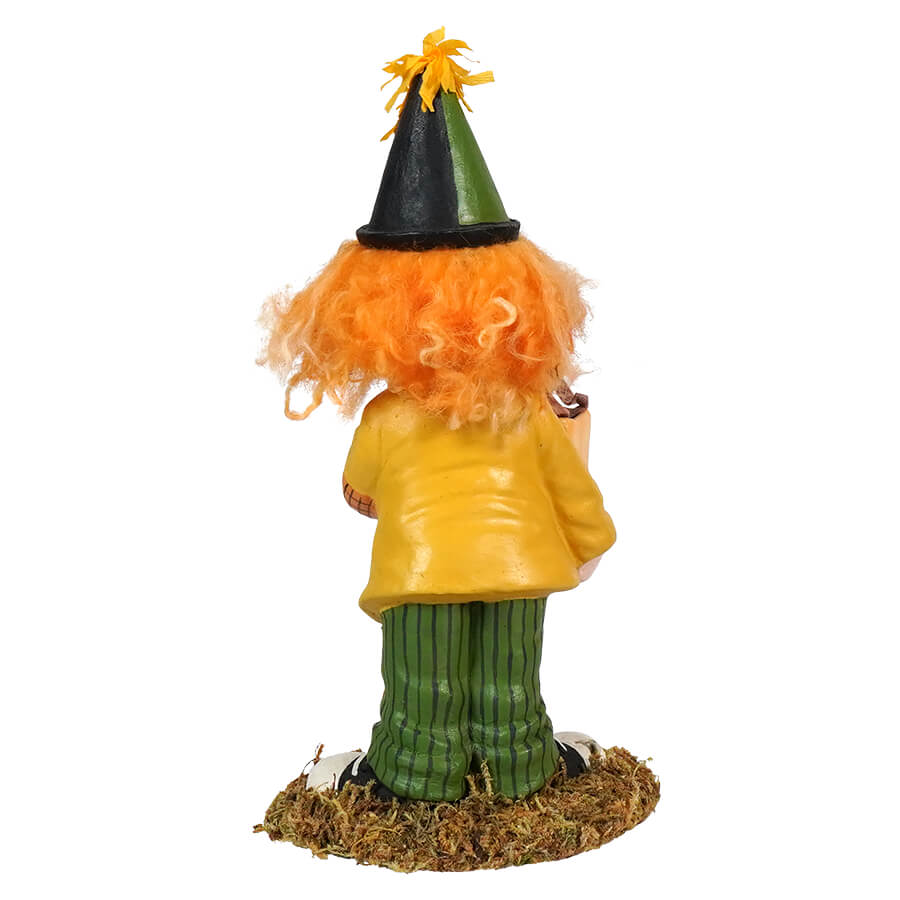 Colorful garden gnome figurine with orange hair wearing a yellow jacket, green pants, and a pointed hat.