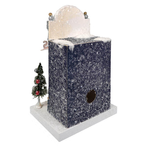 Miniature winter-themed christmas house by cody foster with speckled blue exterior in cocktail bar lounge style village house