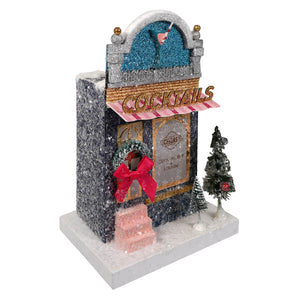 Glittery silver and black cocktail bar miniature with pink striped awning and festive trees cody foster christmas house