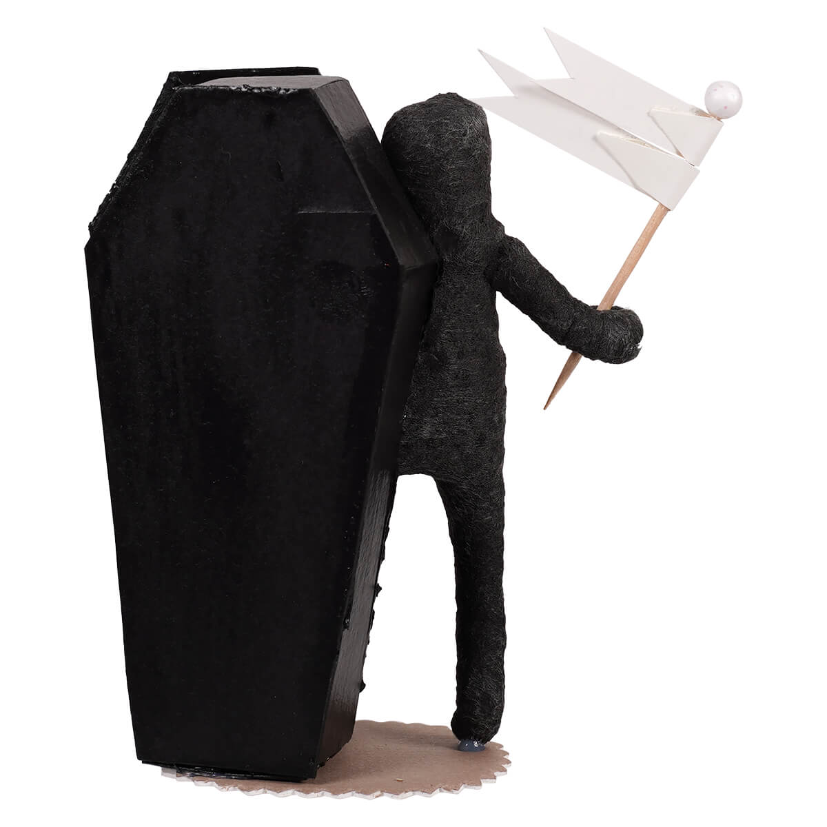 Black coffin-shaped cake topper with wire-wrapped skeleton boy figure holding white paper flag for skeleton decor
