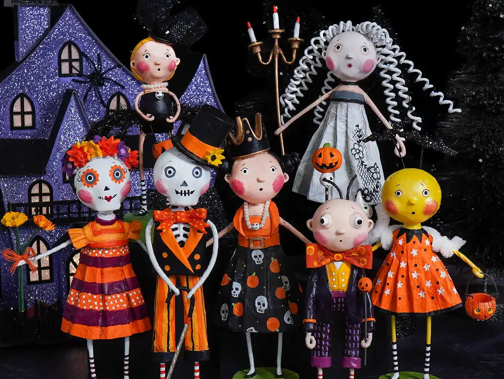A collection of whimsical halloween-themed figurines, each with unique designs and vibrant colors like orange, purple, black, and white.