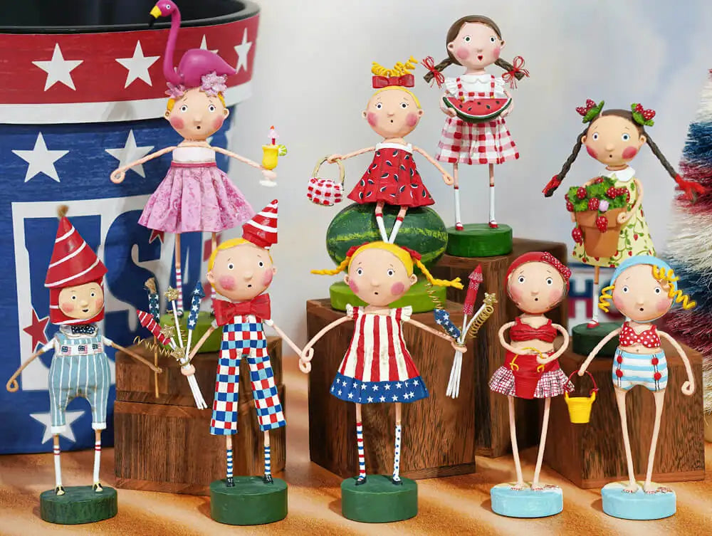 Lori Mitchell's patriotic figures. A collection of children figures dressed in various outfits of red, white, and blue. 