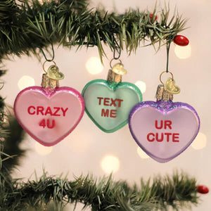 Three heart ornaments gift box set with pink green and purple conversation heart ornaments and red text messages