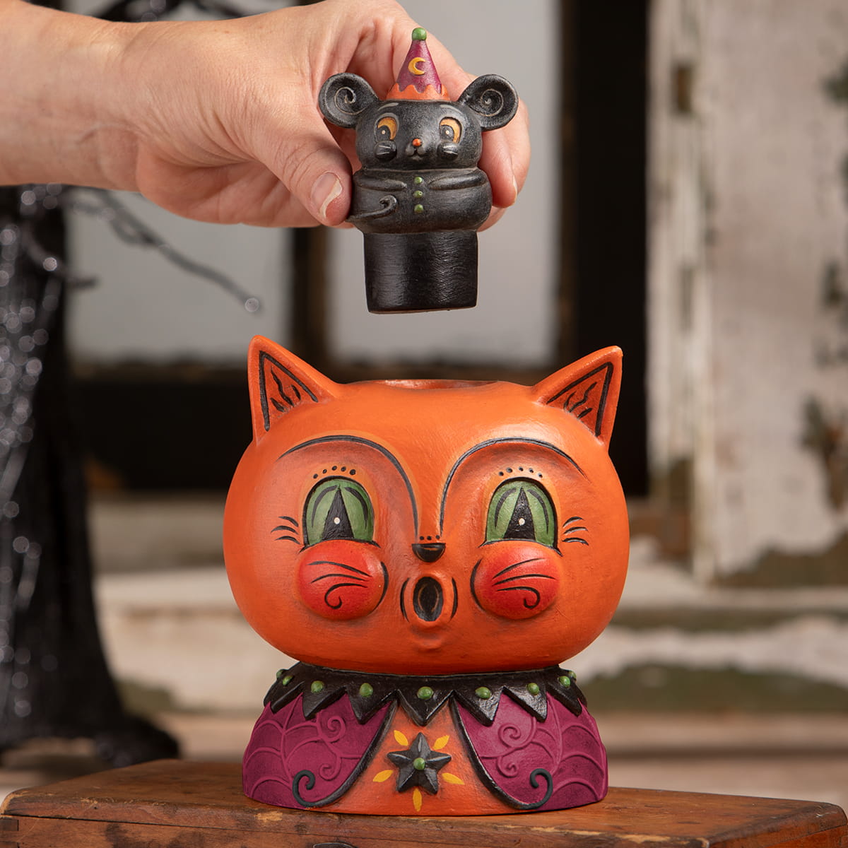 Orange cat-shaped decorative ceramic vase with green eyes and purple collar topped by black mouse figurine perfect for halloween cats decor