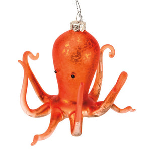Coral octopus ornament made of translucent orange glass with a silver cap and hanging chain for decoration