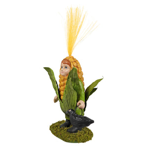 A whimsical bethany lowe corn on the cob figurine featuring a child in a detailed yellow and green corn costume