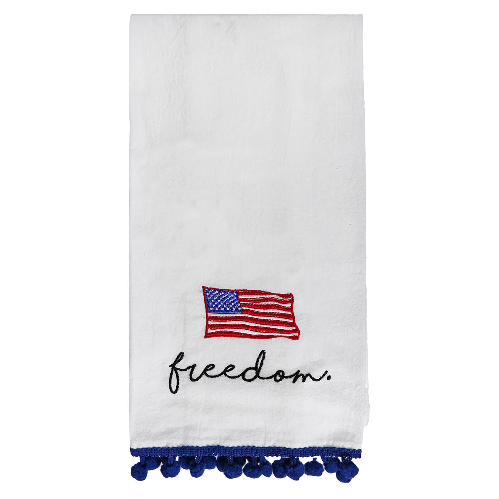 White tea towel with an embroidered American flag, ’freedom’ text, and blue pom-pom trim.