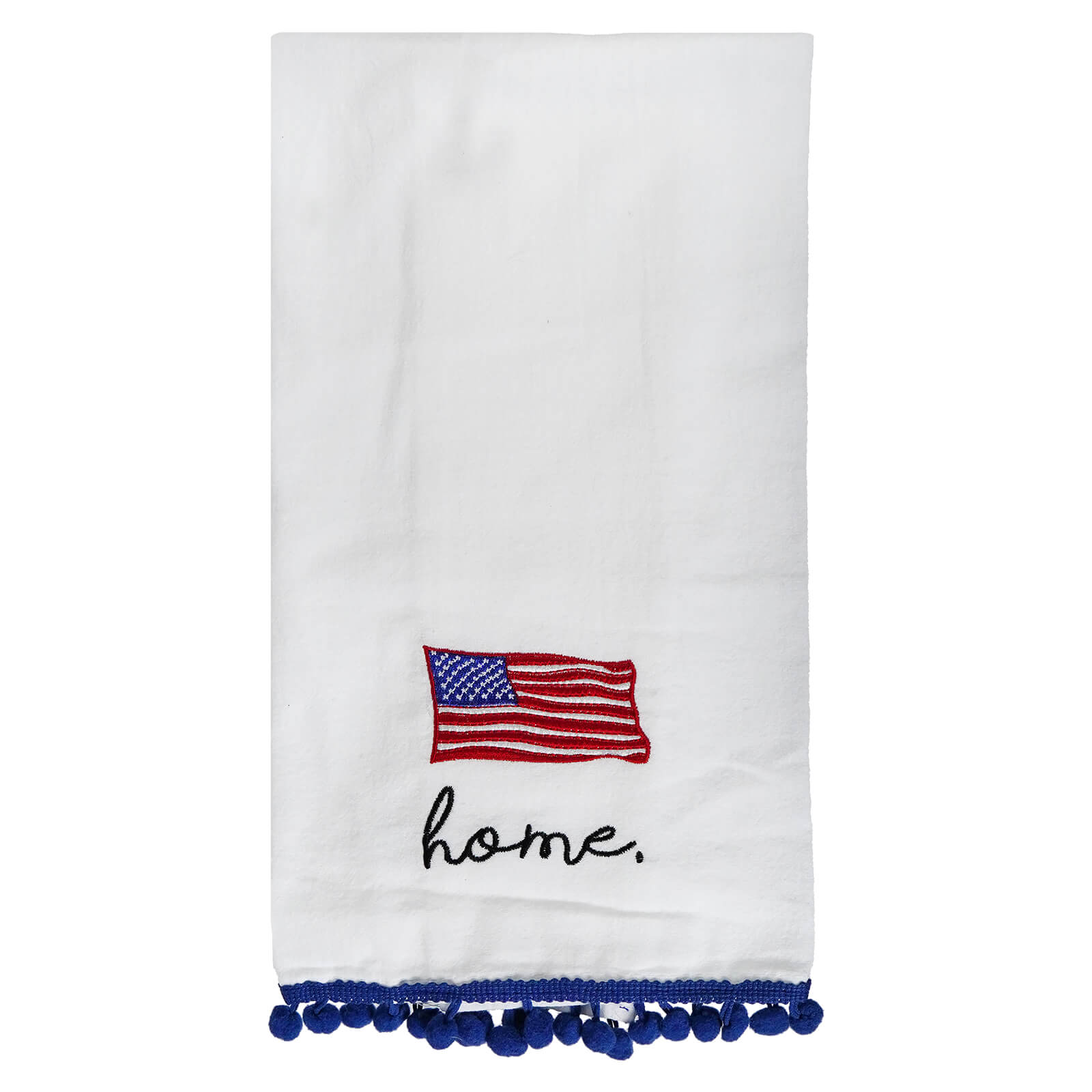 White tea towel with an embroidered American flag, ’home’ text, and blue pom-pom trim.