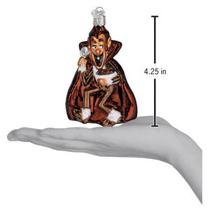 A count chocula ornament featuring a glass vampire in a red cape with white trim and silver tipped shoes for world christmas