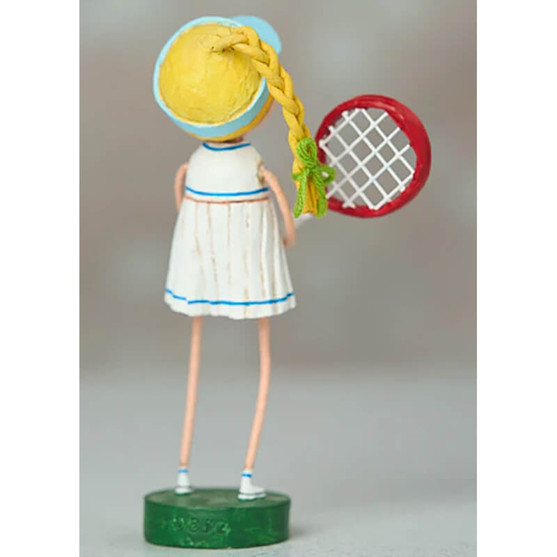 Decorative figurine of a tennis player wearing a white dress with blue trim, holding a racquet.