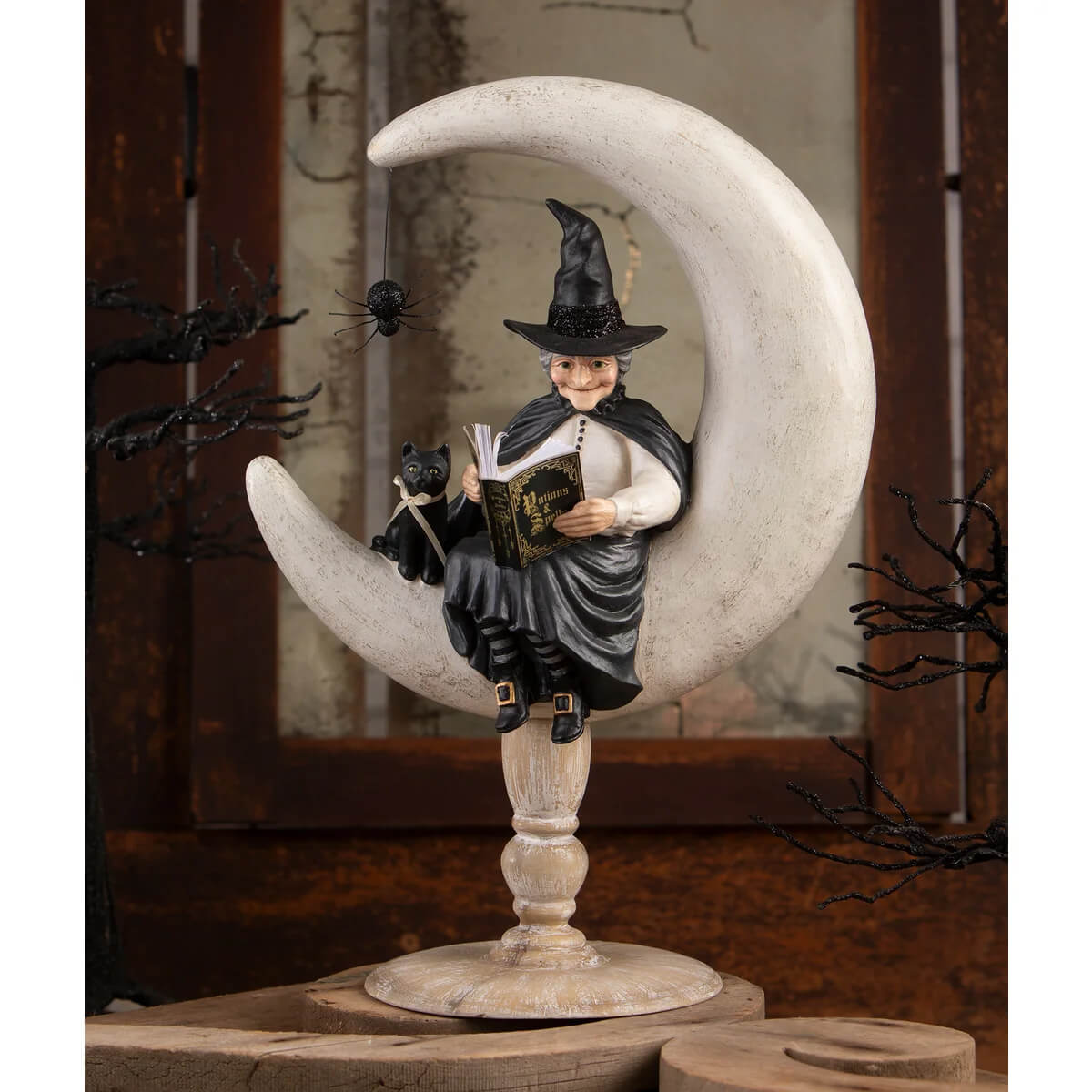 Crescent moon moira halloween witch figurine in black sitting on a silver crescent moon perfect for witch decor